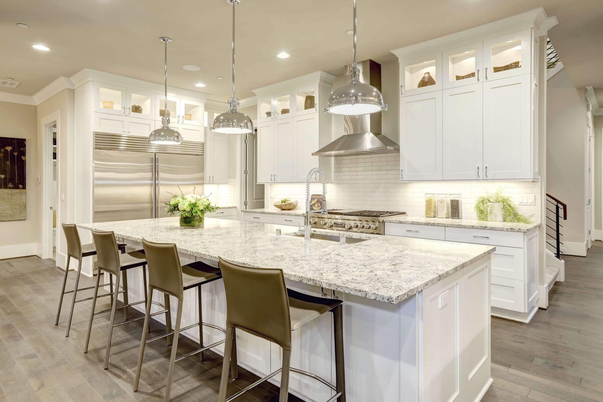 White kitchen design in new luxurious home with white shaker style cabinets