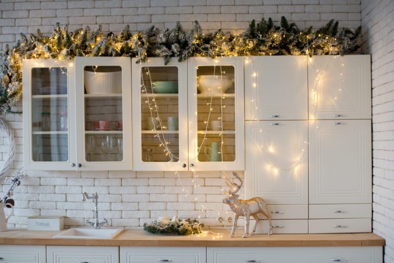 How To Decorate Kitchen Cabinets For Christmas Diamond Kitchen And Bath   Cabinets Decorated For Christmas With Garland And Lights 768x512 