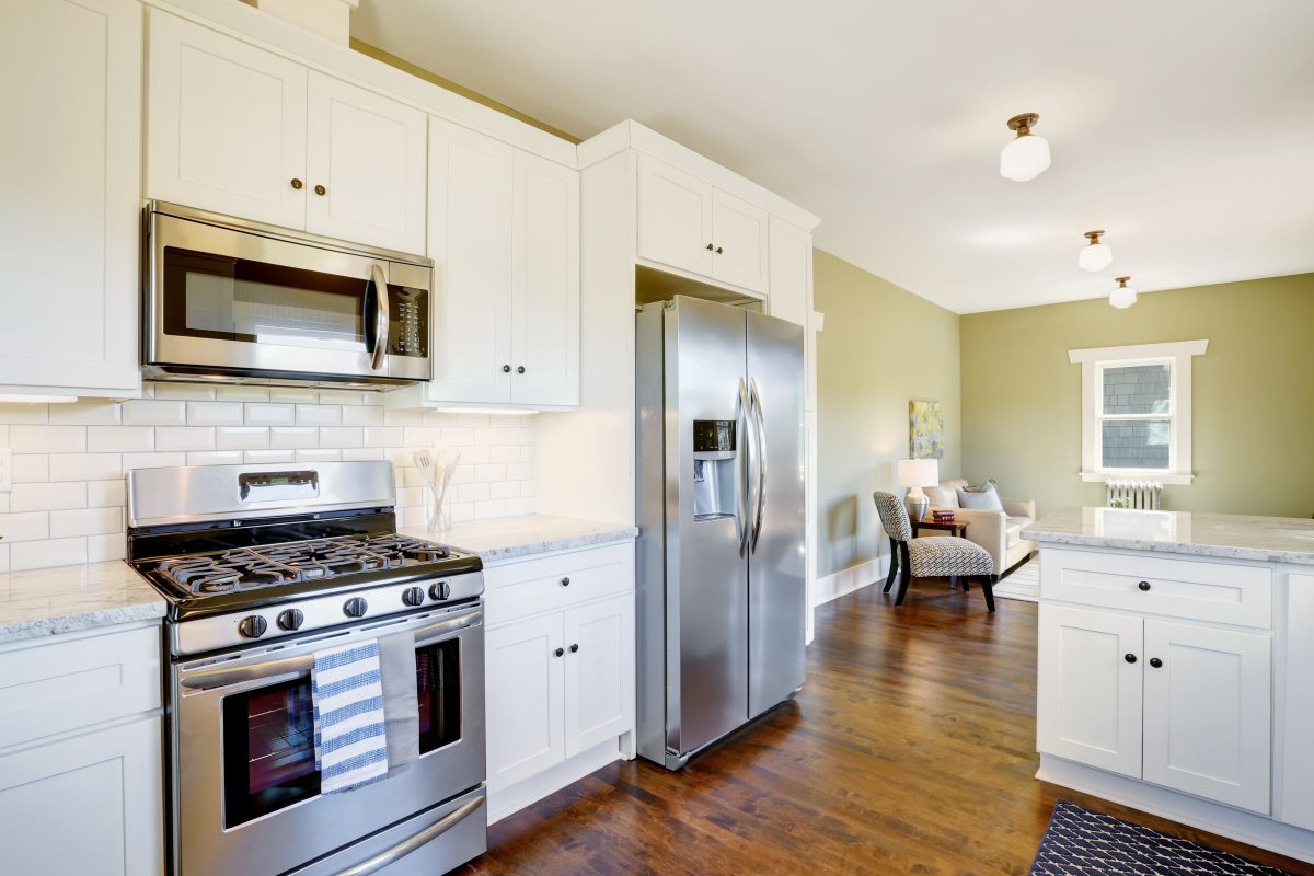 Freshly updated white and green kitchen room interior