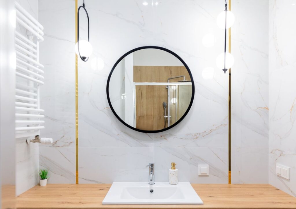 Bold pendant lighting on bathroom vanity