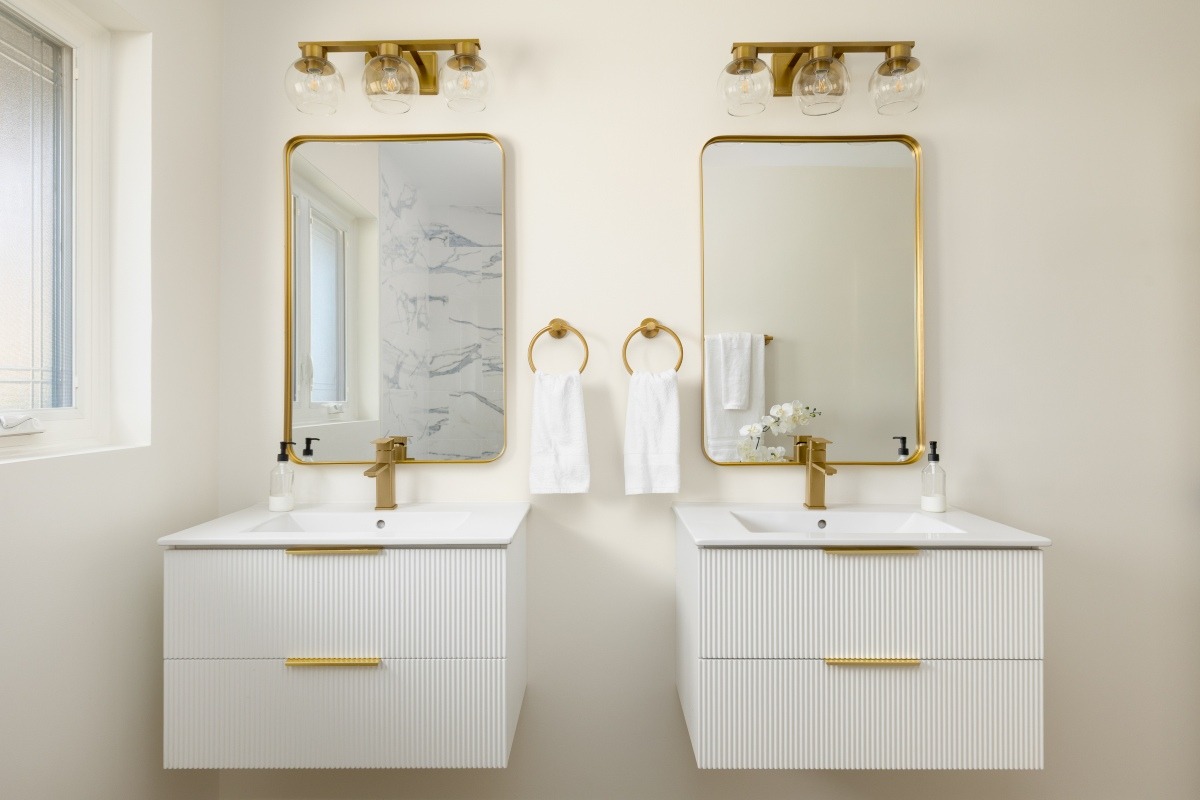 simple bathroom vanity with fluted cabinets and gold fixtures